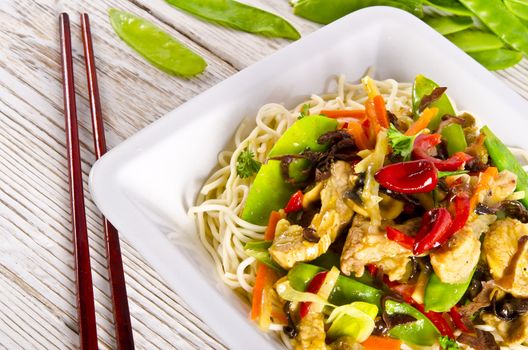 Noodles with pork and vegetables in plum sauce