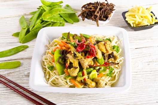 Noodles with pork and vegetables in plum sauce