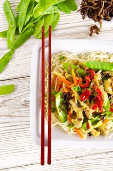 Noodles with pork and vegetables in plum sauce