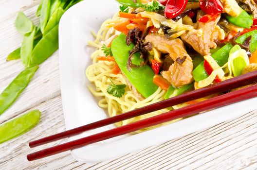 Noodles with pork and vegetables in plum sauce