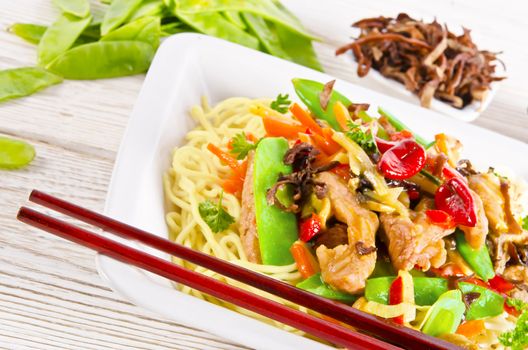 Noodles with pork and vegetables in plum sauce