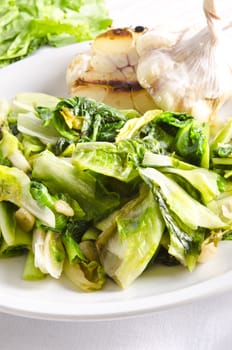 baked Romaine lettuce with garlic and pine cores