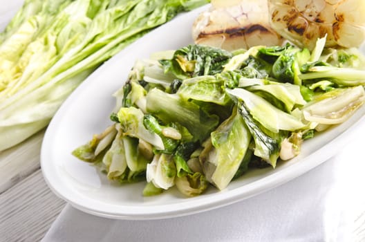 baked Romaine lettuce with garlic and pine cores