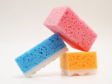 Pink, blue and orange sponge, isolated towards white background