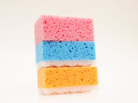 Pink, blue and orange sponge, isolated towards white background