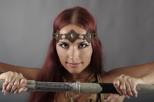 young warrior woman holding sword in her hand