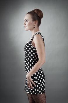 Girl in american 60s style in  polka dot dress