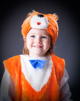 Little baby girl  dressed in a fox suit .Closeup