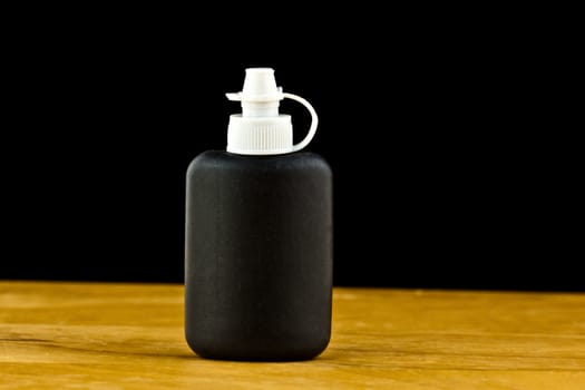 close up of a black cleaning bottle 