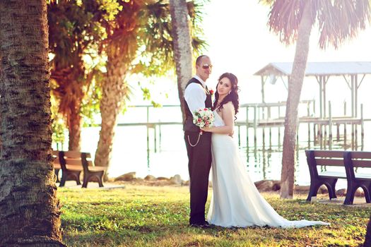 Bride and groom looking happy on the beach 