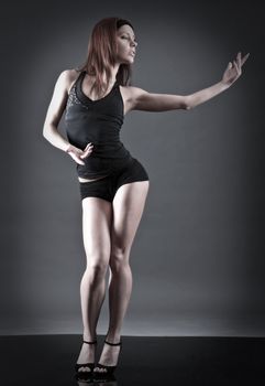 modern style dancer.female performing on  gray background