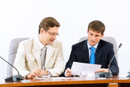 group of business people discussing documents leaning over them