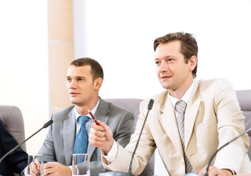 two businessmen sitting in a chair at the table, talk at the conference