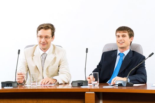 two businessmen sitting in a chair at the table, talk at the conference