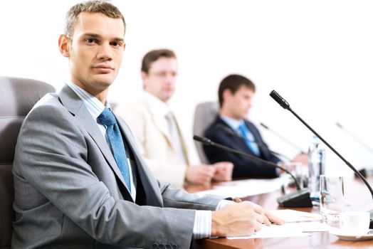 Portrait of a businessman, in the background colleagues communicate with each other