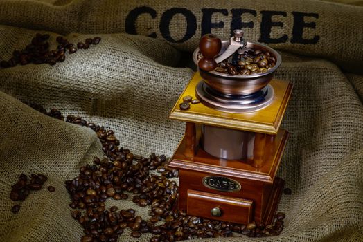 Coffee Mill with beans and burlap. still life