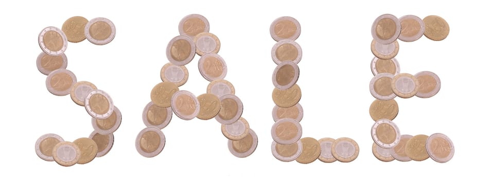 sale - written with coins on white background