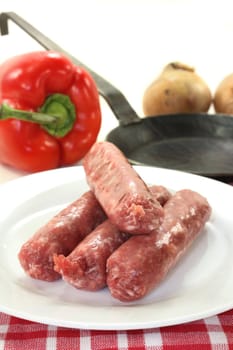 raw fried sausage on a white plate