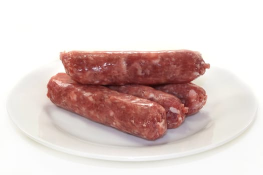 raw fried sausage on a white plate