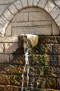 fresh water  from a stone builded fountain