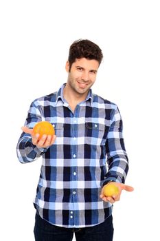 handsome man with a orange and lemon in his hands isolated on a white background