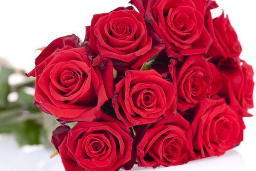 Bouquet of red roses laying on a white background