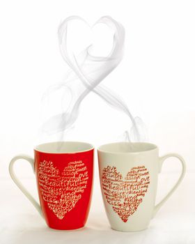 2 coffee cups with hearts creating smoke withe shape of heart on a white background