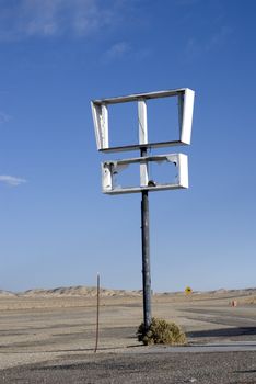 Broken marquee sign on highway in remote area of Nevada.