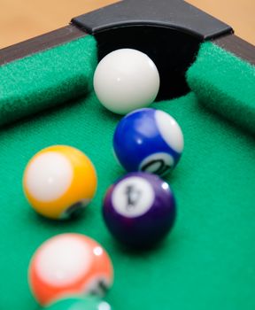 Pool game balls on green felt table