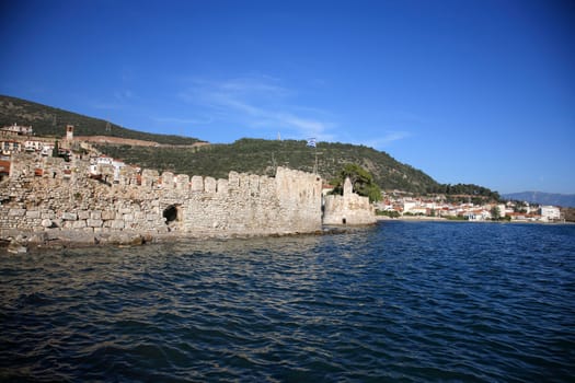 big stone wall of a fort close to the sea