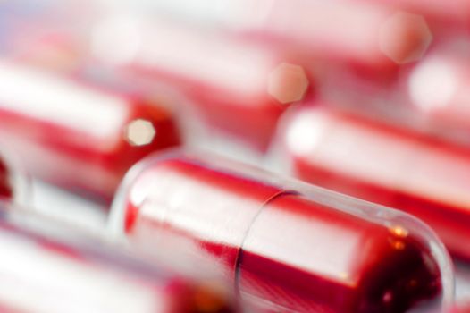 Macro of red capsules on blur background