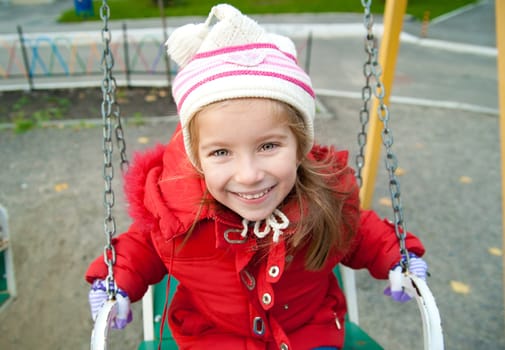 Cute little girl on a playground equipment