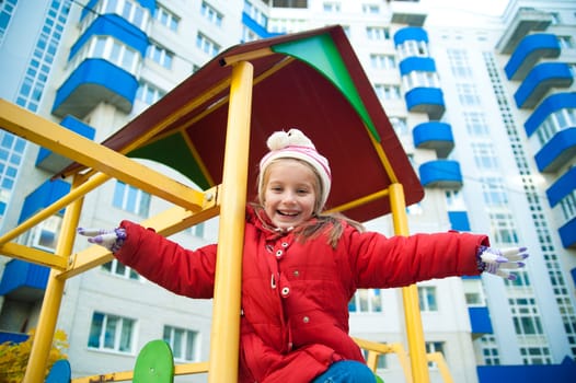 Cute little girl on playground equipment