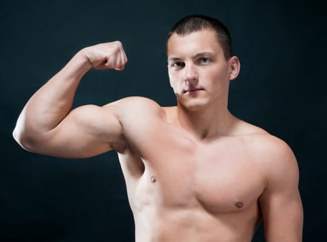 Handsome muscular man isolated on black