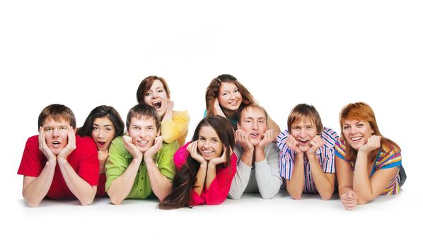 Happy young group of people standing together lying on the floor