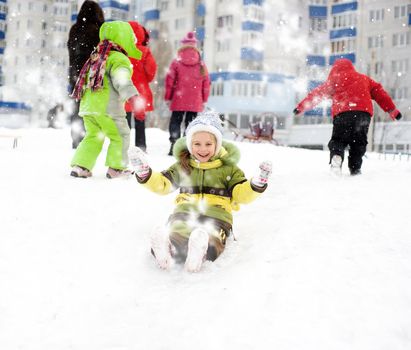 Little girl on the ice slide