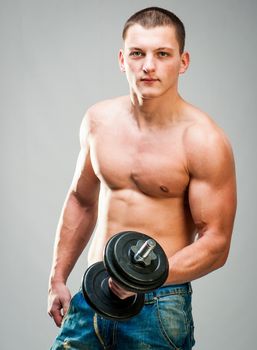 attractive man doing biceps exercise with dumbbells
