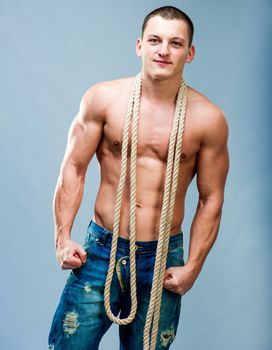 Attractive muscular man with rope