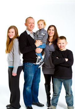 A family of five people on a white isolated background in the studio.