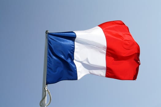 French flag waving firmly on its mast.