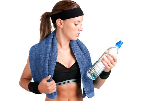 Woman looking at a bottle of water after her workout at the gym, isolated in a white background