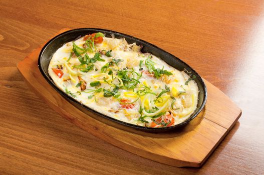 Italian cuisine.Fried eggs with vegetables and spring onions
