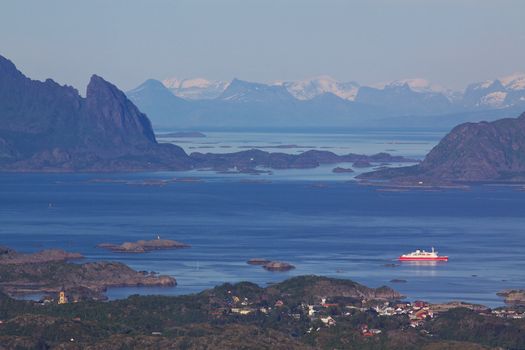 Ferry leaving town of Svolvaer on Lofoten islands in norway with scenic panorama
