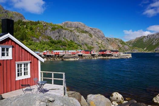 Typical red rorbu fishing huts in village of Nusfjord, unesco heritage on Lofoten islands, Norway