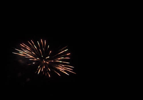 Image of fireworks against a black background with copyspace.
