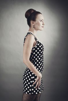 Girl in american 60s style in  polka dot dress