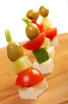  Canape platter with cheese, cucumber,tomato,olives. Shallow depth-of-field. 