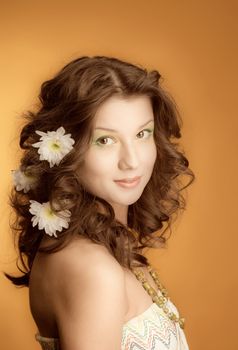 elegant fashionable woman with flowers  on yellow background 