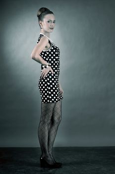 Girl in american 60s style in  polka dot dress 