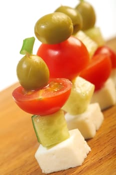 Canape platter with cheese, cucumber,tomato,olives. Shallow depth-of-field. 